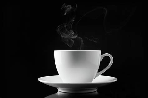 A Cup Of Smoking Hot Coffee On A Black By V2images