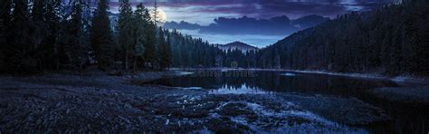 Crystal Clear Lake Near The Pine Forest In Mountains At Night Stock
