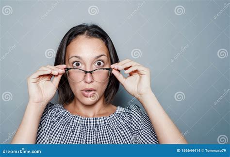 Woman And Shocked Face Expression On Gray Background Stock Photo