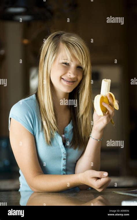 Young Woman Eating A Banana Stock Photo Alamy