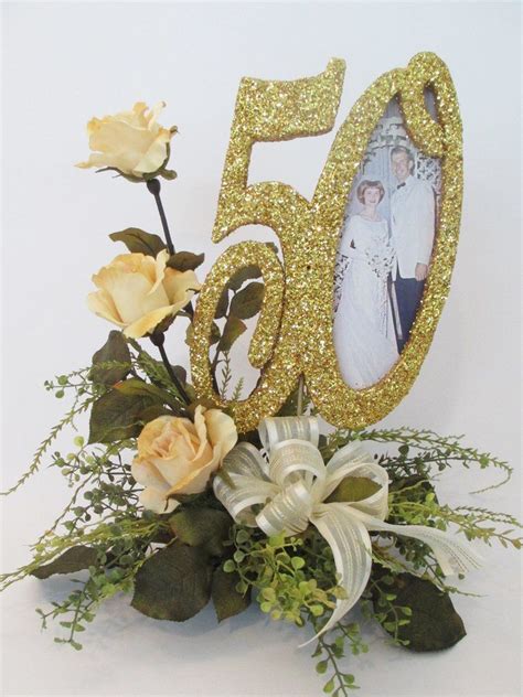 A Bouquet Of Flowers And A 50th Birthday Cake Topper