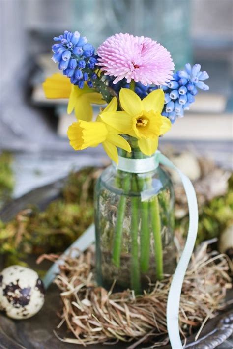Bouquet Of Tiny Spring Flowers In Glass Vase Hay Wreath Around Party