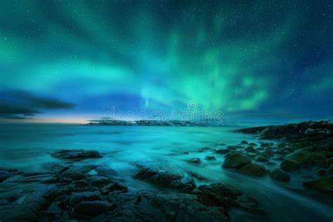 Aurora Borealis Over Rocky Beach And Ocean Northern Lights Stock Photo