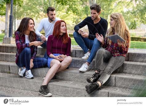 Group Of Young People Together Outdoors In Urban Background A Royalty