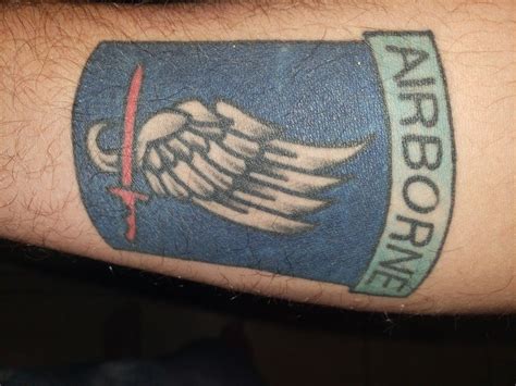 An Arm With A Blue And White Tattoo On It That Says Airbornie Above The