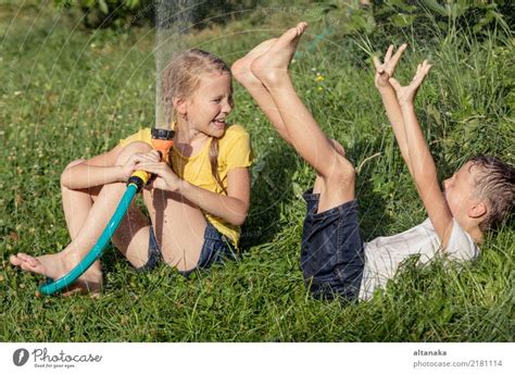 Kleine niedliche adorable Mädchen genießen ein kühles Wasser von ihrer Mutter während heißen