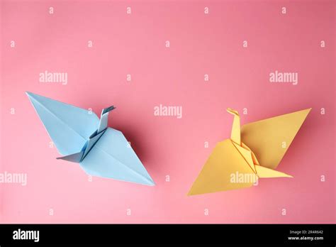 Origami Art Colorful Handmade Paper Cranes On Pink Background Flat
