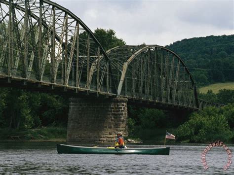 Raymond Gehman A Canoeist Passes Under A Bridge On The Susquehanna