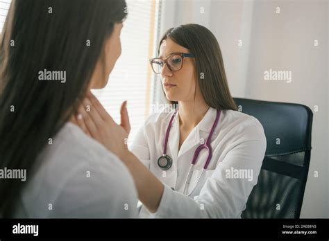 Medical Exam Female Doctor Palpating Lymph Nodes Of A Patient Stock