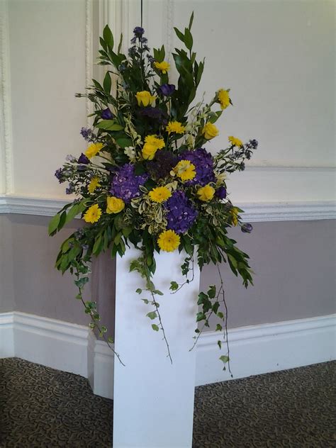For beautifully designed sympathy and funeral flowers, call add style uk in reading, berkshire. Purple and yellow pedestal arrangement | Yellow flower ...