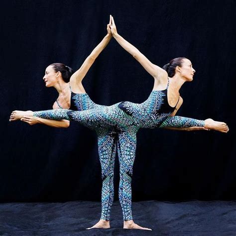 Two Women Are Doing Yoga Poses In Front Of A Black Background