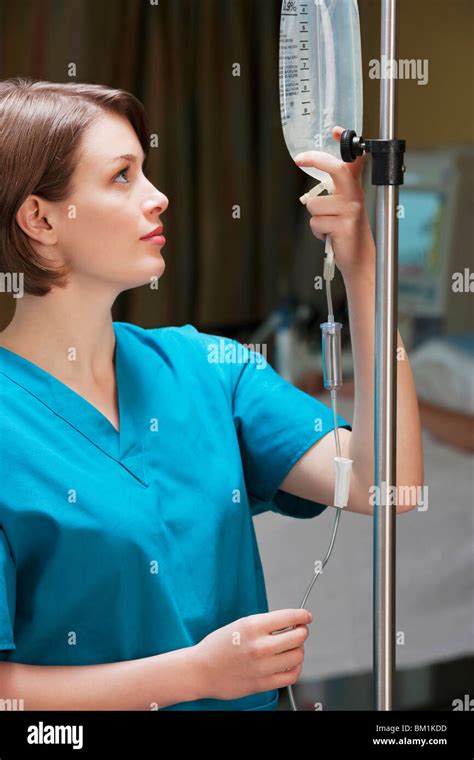 Female Doctor Checking A Saline Drip Stock Photo Alamy