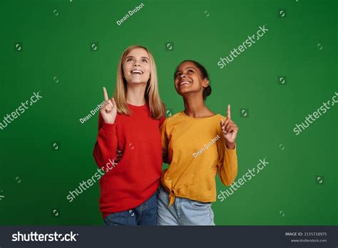 Multiracial Girls Laughing Hugging While Pointing Stock Photo