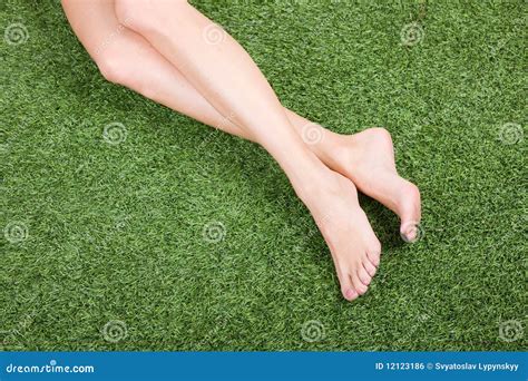 Beautiful Slim Female Feet On Green Grass Royalty Free Stock Image