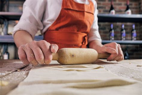 A Person Rolling The Dough By Stocksy Contributor Danil Nevsky