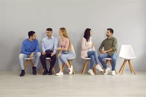 Smart Young People Sit In Line For Interviews And Communicate With Each