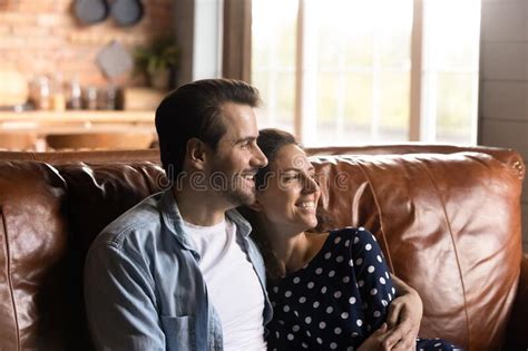 Smiling Young Couple Relax On Couch Dreaming Stock Image Image Of