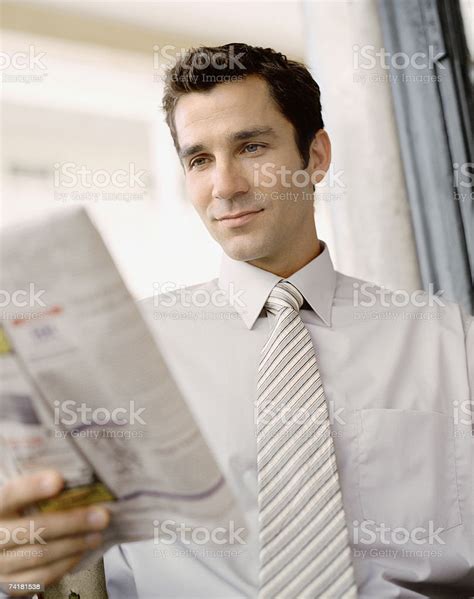 Portrait Of A Businessman Reading Newspaper Stock Photo Download