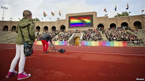 Demonstrators Raise Rainbow Flags At Stockholms Olympic Stadium During
