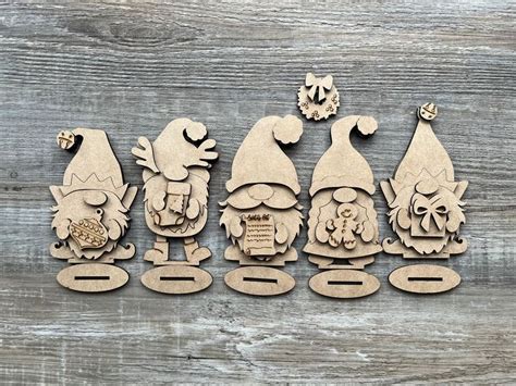 A Group Of Wooden Gnomes Sitting Next To Each Other