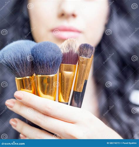 Beautiful Woman At Beauty Salon With Set Of Makeup Brushes Stock Photo