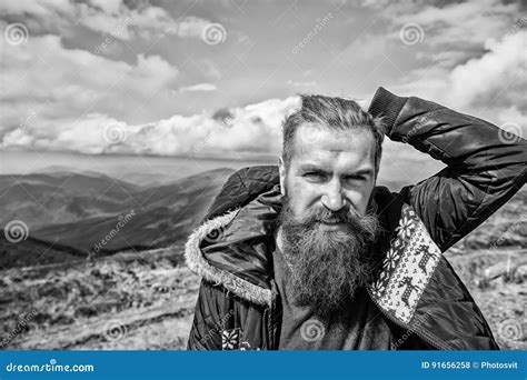 Brutal Man Bearded Hipster In Winter Jacket At Mountain Outdoor Stock