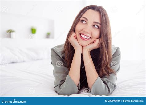 Photo Of Charming Dreamy Young Woman Grey Nightwear Lying Bed Arms