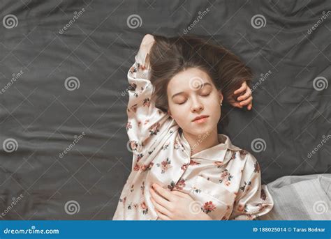 Top View Of Attractive Young Woman Sleeping Well In Bed Hugging Soft