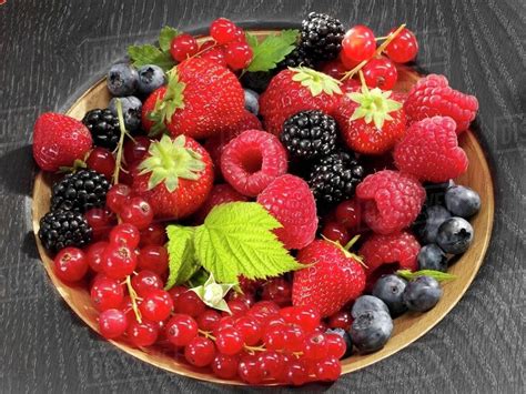 Assorted Berries In Wooden Bowl Stock Photo Dissolve