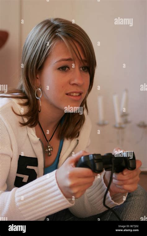 Teenage Girl Playing Video Game And Concentrated With Playstation Game