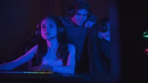 Two Beautiful Gamer Girls Playing An Online Game In The Neon Gaming