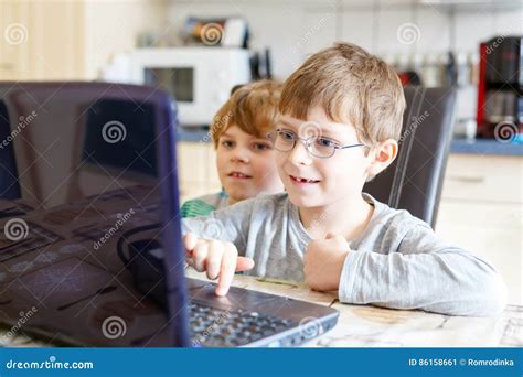 Two Kids Boys Playing Online Chess Board Game On Computer Stock Image