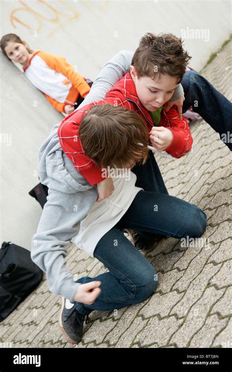 Two Boys Arguing In The Schoolyard A Girl Watching Stock Photo Alamy