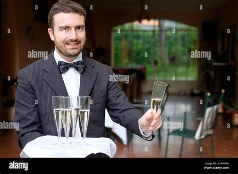 Professional Waiter In Uniform Is Serving Champagne Stock Photo Alamy