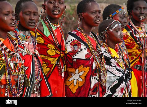Masai Women Wearing Traditional Dress In A Village Near The Masai Mara