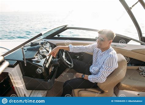 Aspirational Successful Businessman Standing By Luxury Boats And Yachts