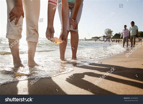 Mother Daughter Picking Shell On Beach Stock Photo Shutterstock