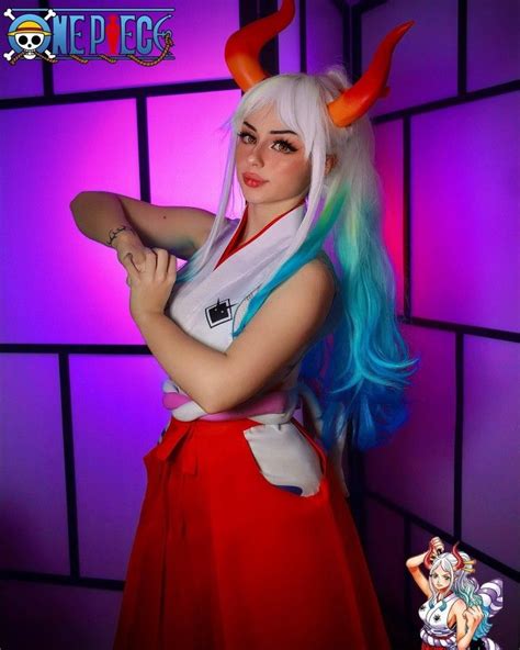 A Woman With Long Blue Hair And Horns On Her Head Posing In Front Of A