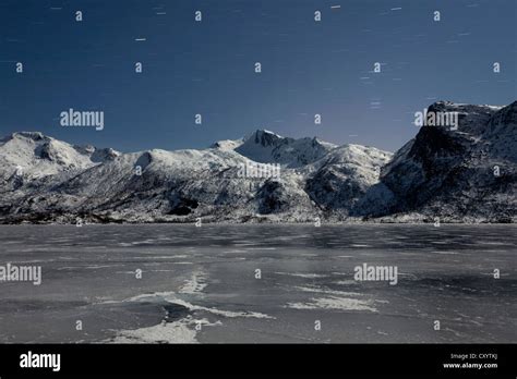 Frozen Lake And Mountain At Night On The Lofoten Islands Norway