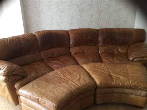 Curved Distressed Tan Leather Sofa Plus 2 Matching Pouffes In Milton