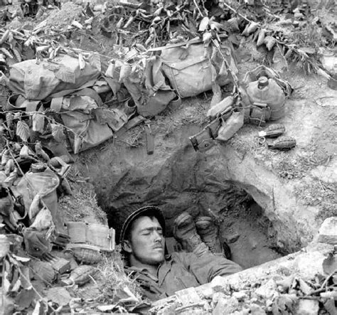 two u s infantrymen share a foxhole only yards from the frontlines after the allied invasion of
