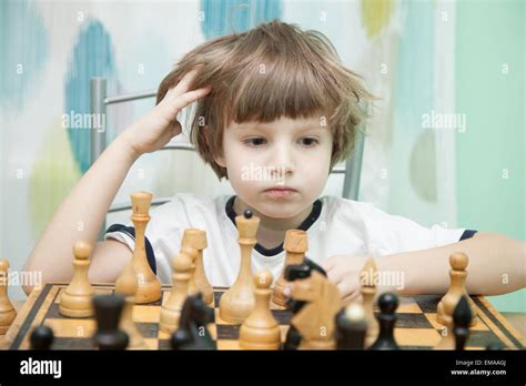 Portrait Of A Little Boy Playing Chess Stock Photo Alamy
