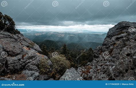 Forest Landscape On A Rocky Mountain Rain Clouds Are Seen In The