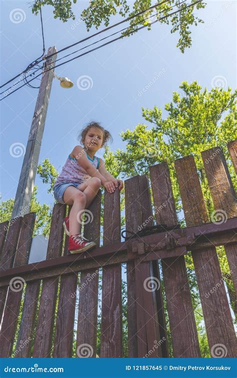 Girl Climbs The Fence On A Summer Day Stock Image Image Of Girl Hair 121857645