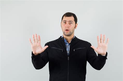 Free Photo Young Man Showing Palms In Surrender Gesture In Shirt