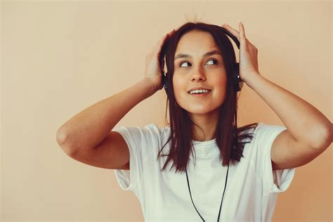 Dreamy Young Woman Listening To Music In Headphones · Free Stock Photo