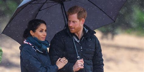 Prince Harry Shelters Meghan Markle From The Rain With Umbrella In