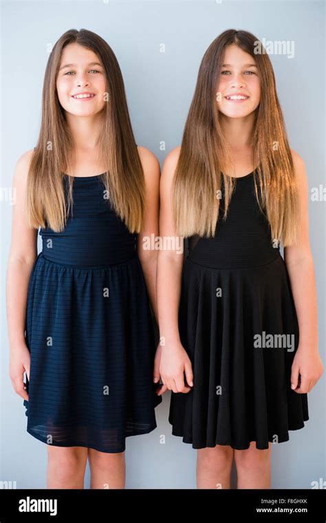 Caucasian Twin Sisters Wearing Dresses Stock Photo Alamy