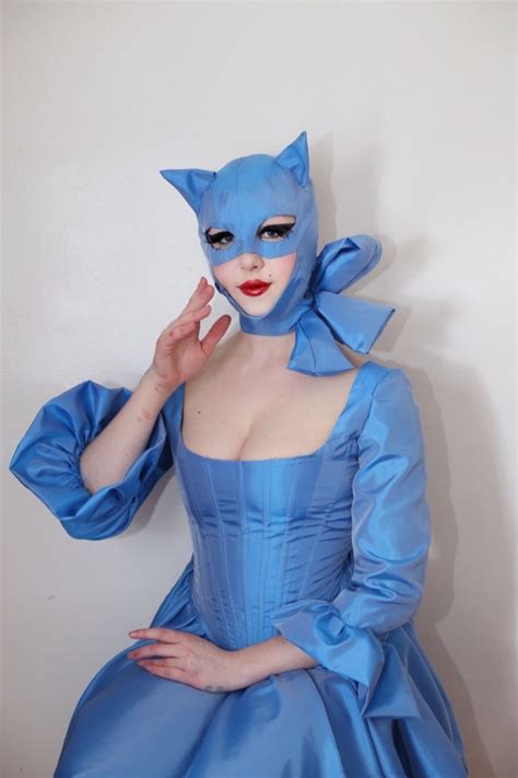 A Woman In A Blue Cat Costume Poses For The Camera