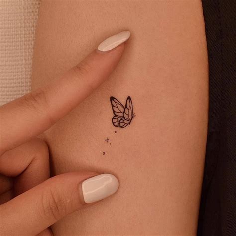 Fine Line Butterfly Tattoo On The Upper Arm